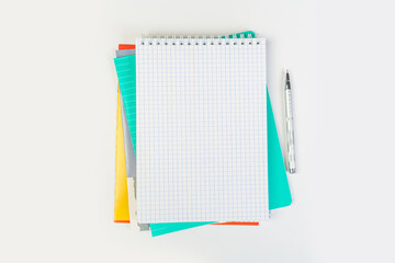 top view of an open notebook with a pen on a gray background, school notebooks with a spiral spring, office notepad. desktop concept, learning