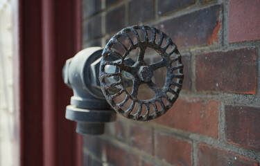 Old round handle on the valve of the building