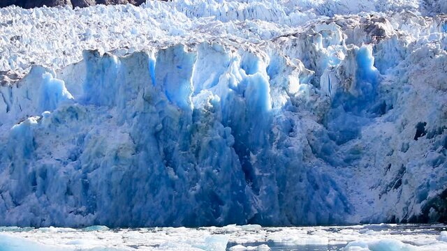 Hubbard Glacier wall. Located in eastern Alaska near Juneau showing the amazing blue colours as pieces of the ice falls.
