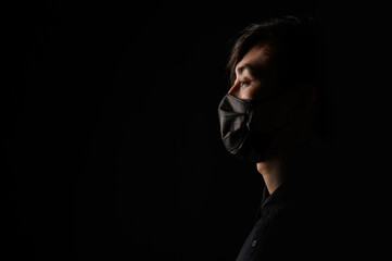 Asian man in black medical mask. Coronavirus is a virus that is endemic in China.