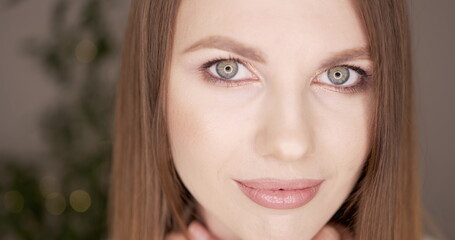 Beauty woman face with green eyes looking at camera. Skin care treatment or cosmetic ads concept....