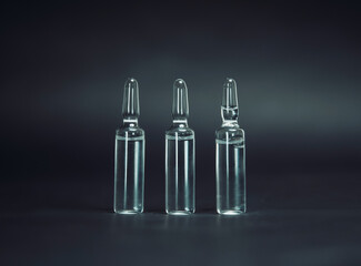 medical glass ampoules on a dark background.