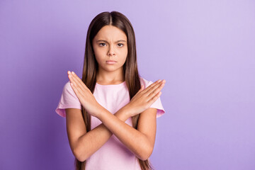 Photo of attractive serious schoolgirl dressed pink t-shirt showing no stop gesture isolated purple color background
