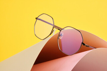 fashion trendy eyes glasses for correcting vision on a creative background, wave from paper,...
