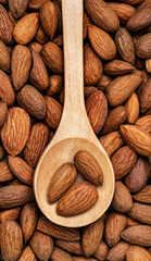 Almonds on wooden spoon. Almonds background.Selective focus.Top view.