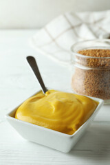 Concept of sauce with mustard on white wooden table