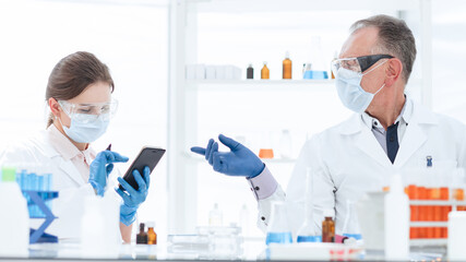 scientist and a laboratory assistant work in a medical laboratory