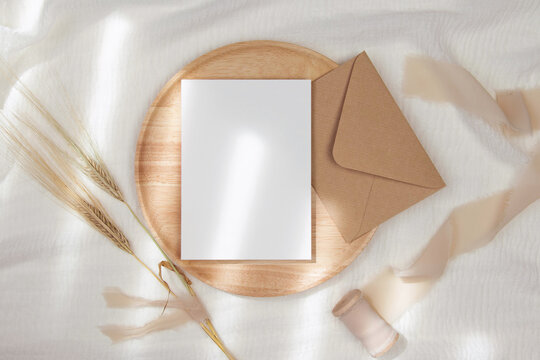 5x7 Invitation Card Mockup With Craft Envelope On Wooden Plate