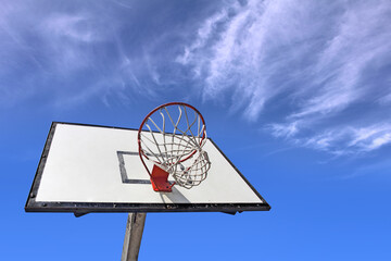 Basketball backboard on the school basketball court under blue sky