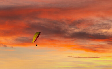 Paraglider flying in the beautiful sky against the background of clouds.