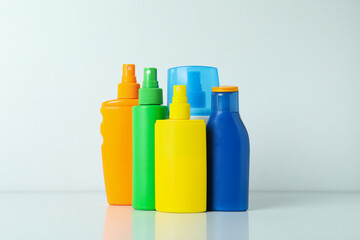 Blank bottles of sunscreen on white background