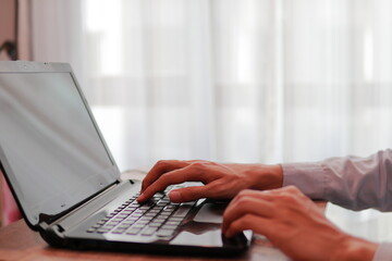 person typing on a laptop