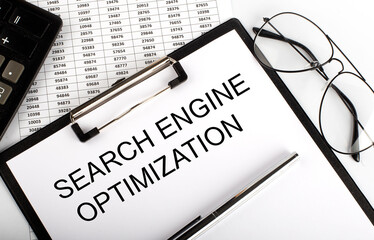 Paper with text SEO Search Engine Optimization on the table on the chart