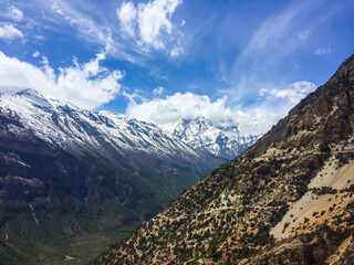Fantastic mountains view with the valley, clouds on the blue sky, power of the mountains, natural colors