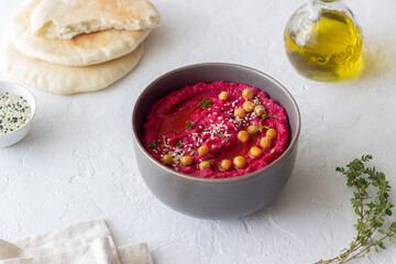 Beet hummus in a gray bowl. Healthy eating. Vegetarian food.