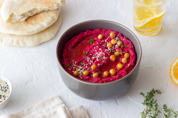 Beet hummus in a gray bowl. Healthy eating. Vegetarian food.