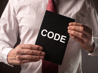 Male hands with legal code with laws, attorney, lawyer