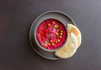 Beet hummus in a gray bowl. Healthy eating. Vegetarian food.