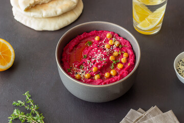 Beet hummus in a gray bowl. Healthy eating. Vegetarian food.
