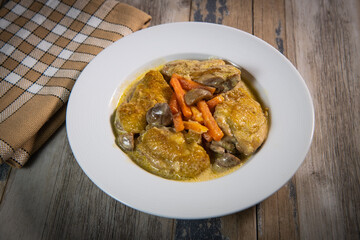 Recipe for chicken fricassee in white wine, with a carrot and mushroom planter, High quality photo