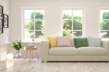 White living room with sofa and summer landscape in window. Scandinavian interior design. 3D illustration