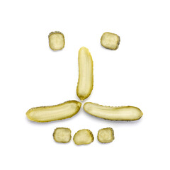 . Pickled cucumbers isolated on a white background. The shape of a human face is made of cucumbers.