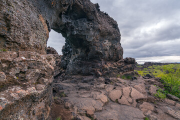 Basalt arch in the Dimmu Borgir area of northern Iceland. Cold and cloudy day in volcanic land.