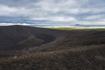 View of the Myvatn lake from the rim of Hverfjall volcano in northern Iceland on a cold, cloudy day. Volcanic landscape in the cold weather.