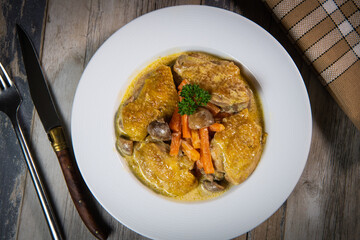 Recipe for chicken fricassee in white wine, with a carrot and mushroom planter, High quality photo