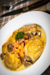 Recipe for chicken fricassee in white wine, with a carrot and mushroom planter, High quality photo