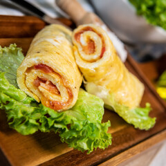 Tomato-rolled egg omelette recipe on a bed of salad, High quality photo