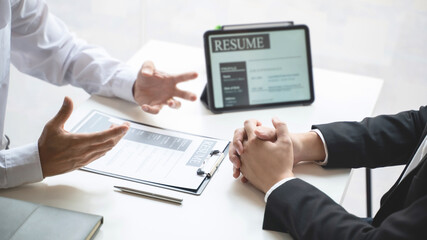 Examiner reading a resume during job interview at office