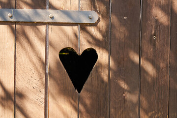 Heart in wooden door in outhouse toilet