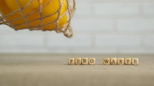Eco bag movement. A nice yellow pepper in the string eco mesh on the table in the room.