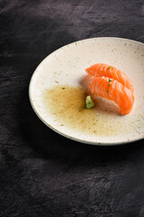 Nigiri salmon sushi with green tea