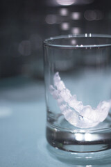 Transparent tooth aligner inside a crystal glass
