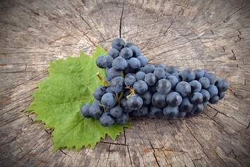 Blue grapes on wooden background. Muscat wine grape.