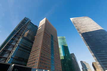 Fototapeta na wymiar Modern Office buildings and blue sky. Japan, Shinjuku Ward, Shiodome, Tokyo. Shiodome, a redeveloped business and leisure district near Tokyo Bay.