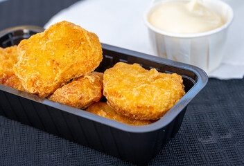 Street or take away fast food, chicken nuggets with mayonnaise sauce