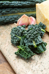 Cooking with black flat leaves of cavolo nero tuscan cabbage