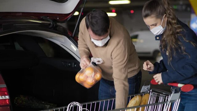 Tracking video of couple packing groceries during a pandemic. Shot with RED helium camera in 8K.