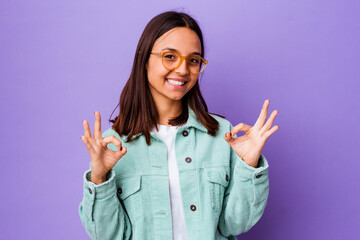 Young mixed race woman isolated cheerful and confident showing ok gesture.