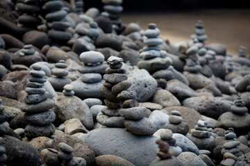 Fototapeta na wymiar pebbles balancing next to a beach