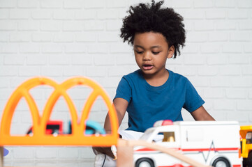 Happy black people African American child play toy at home 