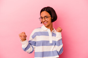 Young mixed race woman isolated on pink background dancing and having fun.