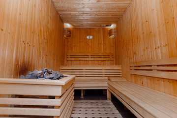 Fototapeta na wymiar Interior of Finnish sauna with heater and stones, classic wooden sauna, Finnish bathroom