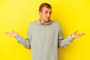 Young caucasian man isolated on yellow background