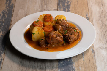 Navarin Lamb Shank Stew on wood table and and potatoes, High quality photo
