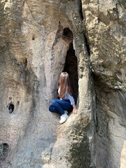 child climbing on a rock