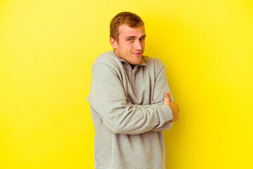 Young caucasian man isolated on yellow background